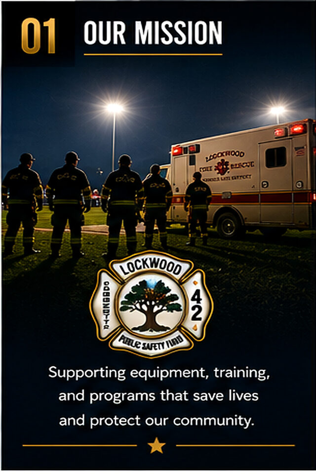 Crews beside the ambulance under the field lights